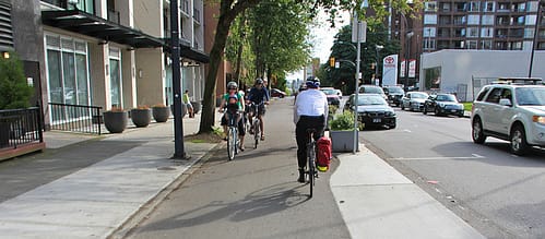 Family riding bicycles in city.